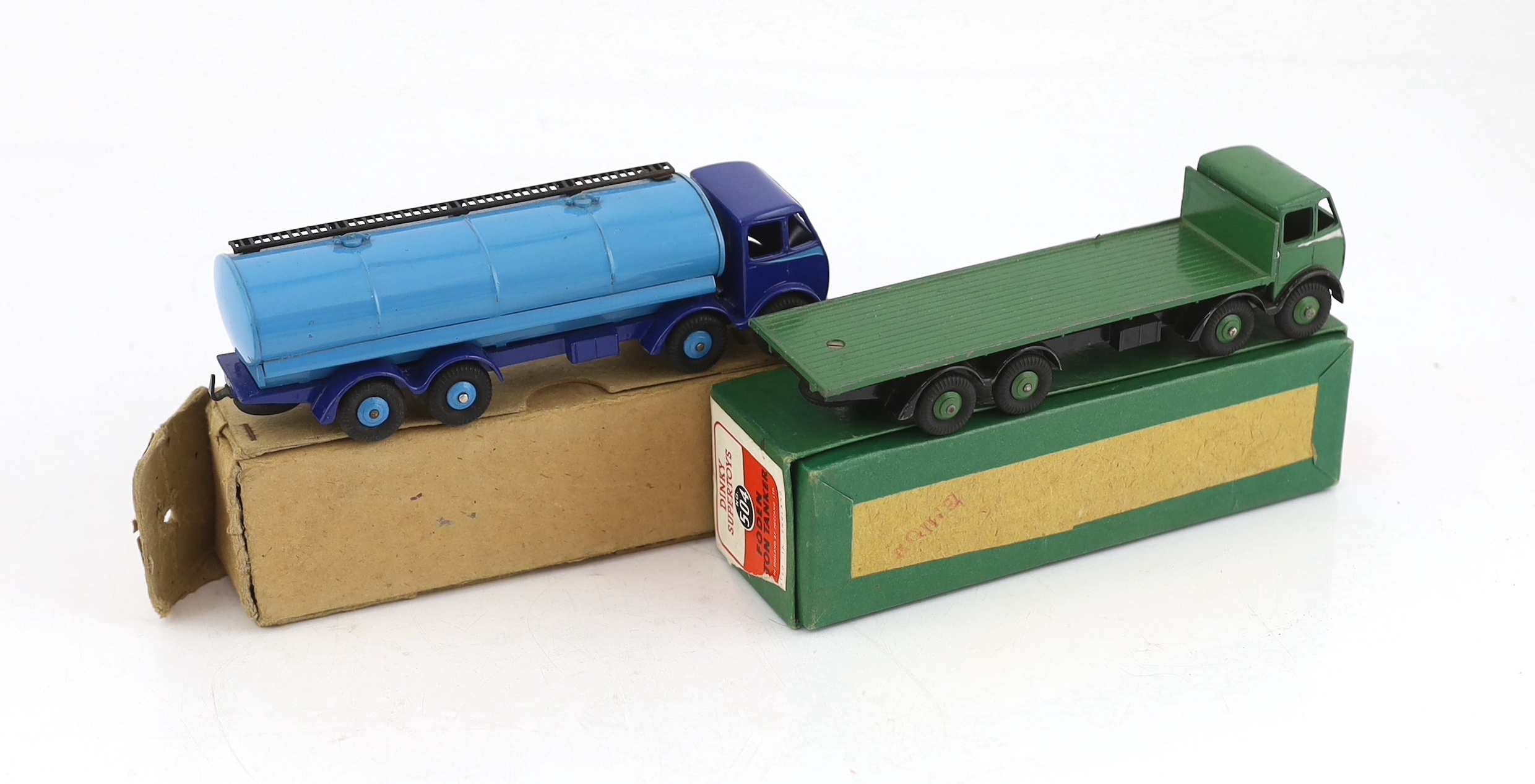 Two boxed Dinky Supertoys first type Fodens; a 14-ton tanker (504), with dark blue cab and chassis, and pale blue tank and wheels and a Flat Truck (502), in green with silver flash, in correct colour-marked box